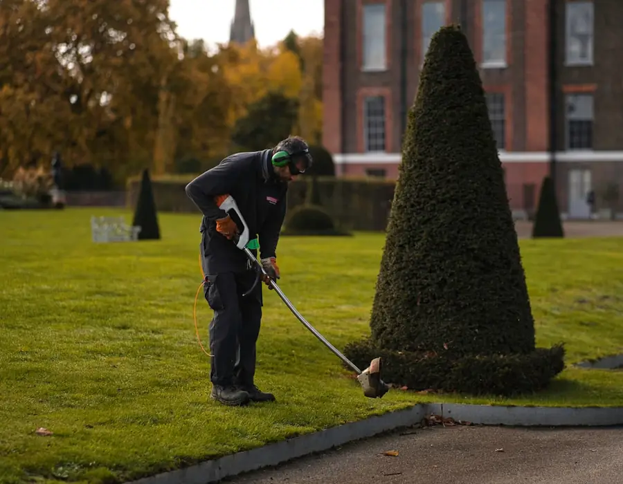 Groundskeeper mowing a lawn