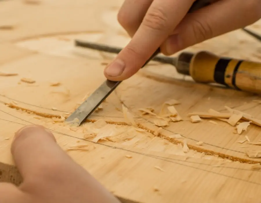 Chisel cutting into a length of pine