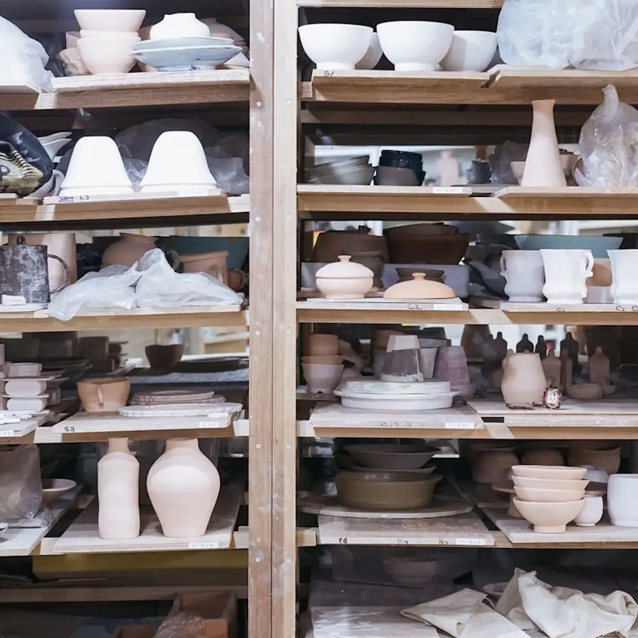Stacked stoneware on studio shelves